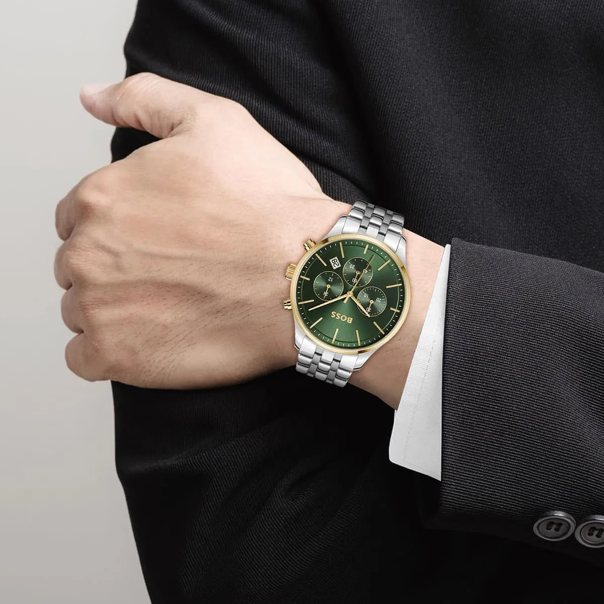 Hugo Boss Avery chronograph watch worn on wrist showing green dial and gold-tone chronograph pushers