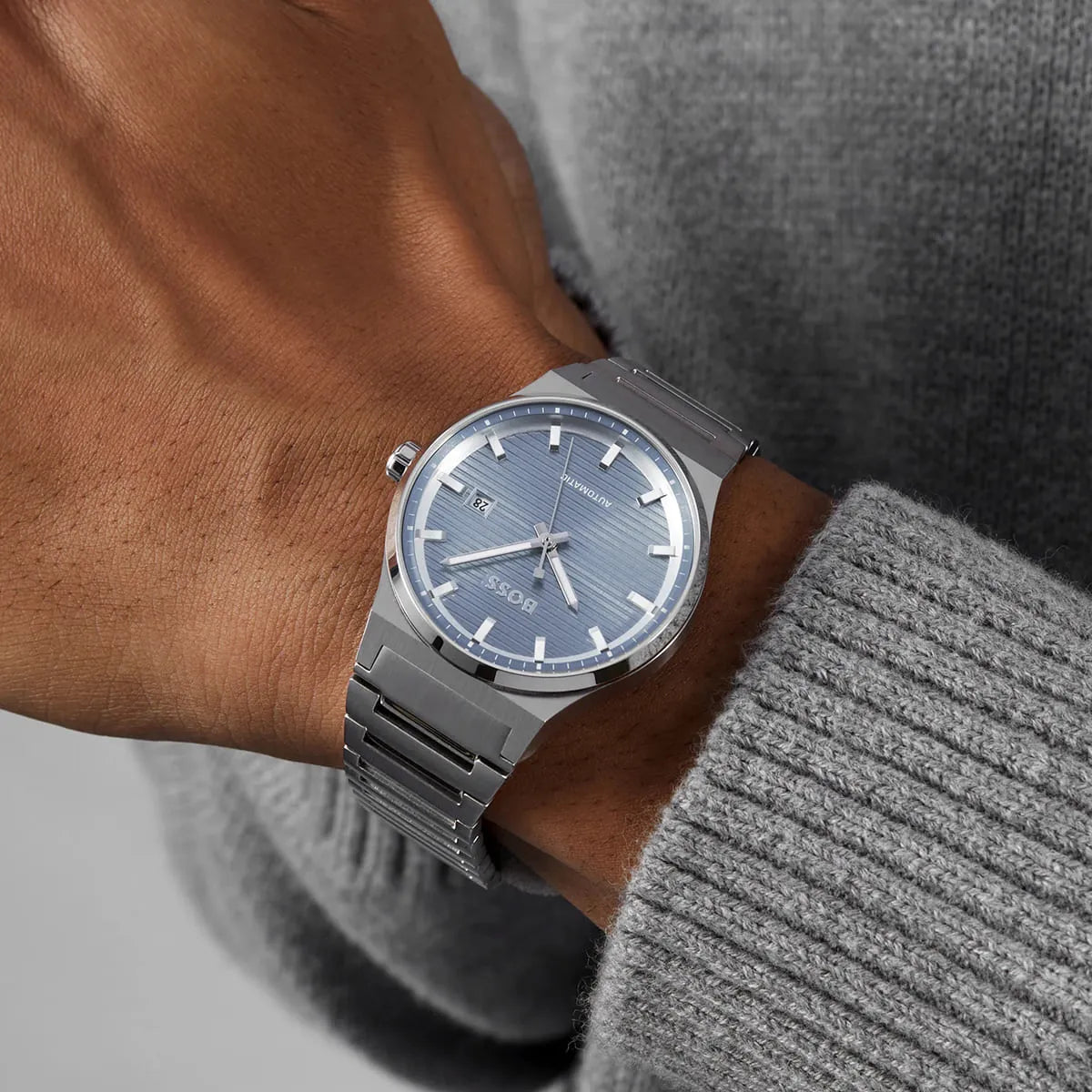 Hugo Boss Candor automatic watch worn on wrist with blue dial visible