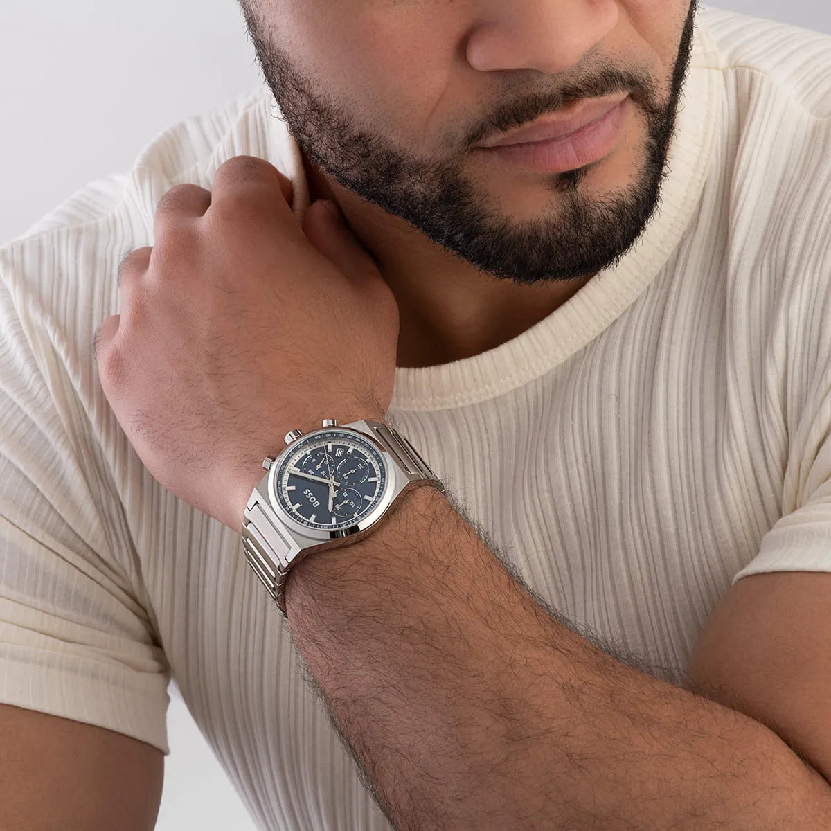 Man wearing Hugo Boss Candor watch with blue dial and silver metal bracelet
