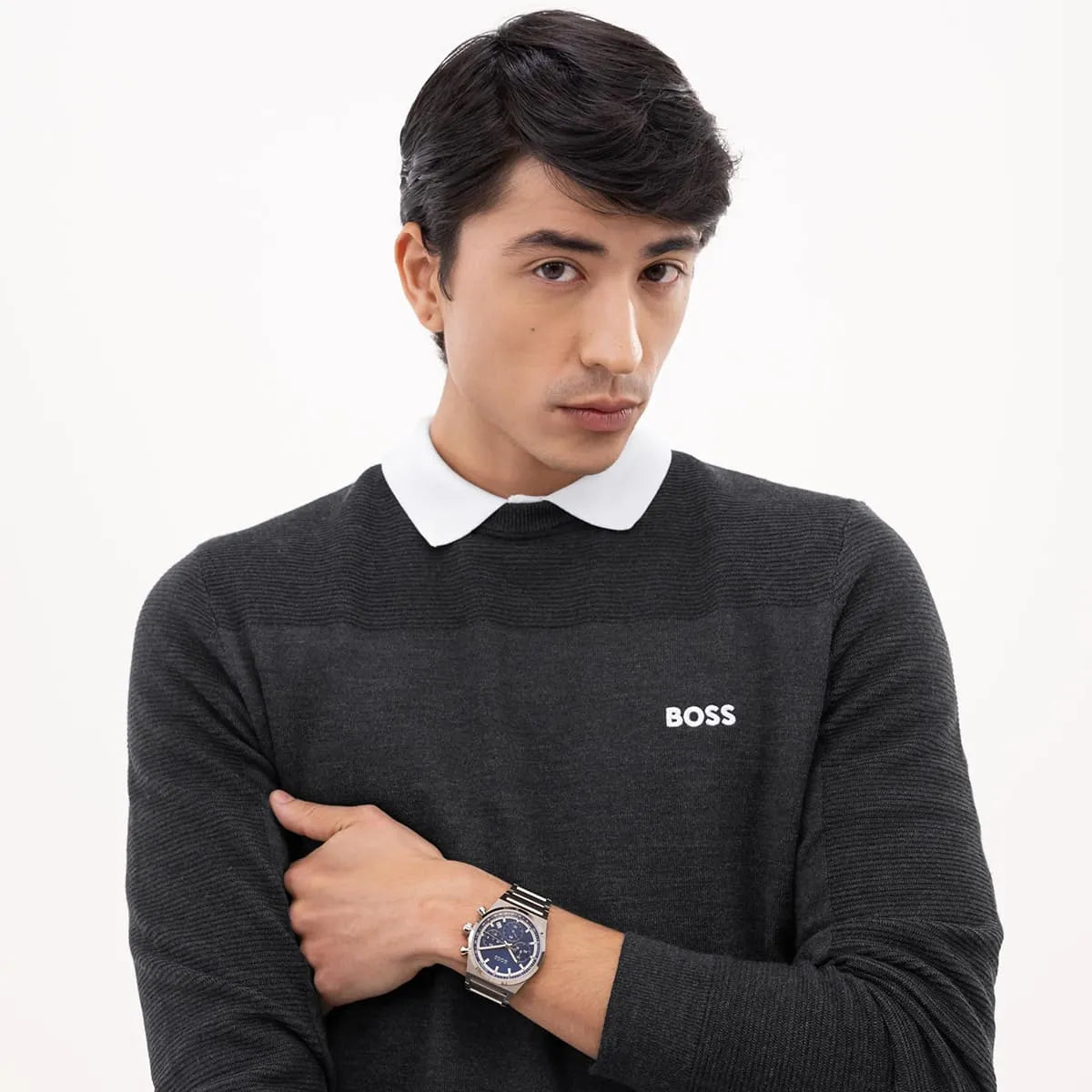 Man in black shirt wearing Hugo Boss Candor chronograph watch on wrist