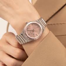 Hugo Boss Candor Sport women's watch worn on wrist with pink dial and silver bracelet