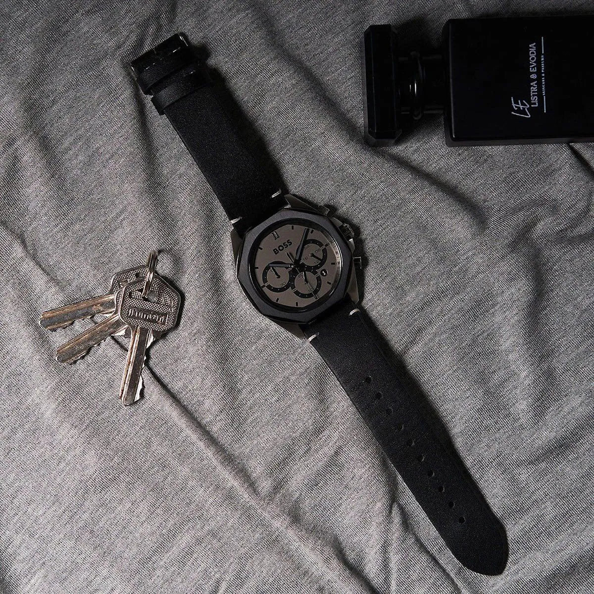 Hugo Boss Cloud watch with keys and accessories displayed on fabric