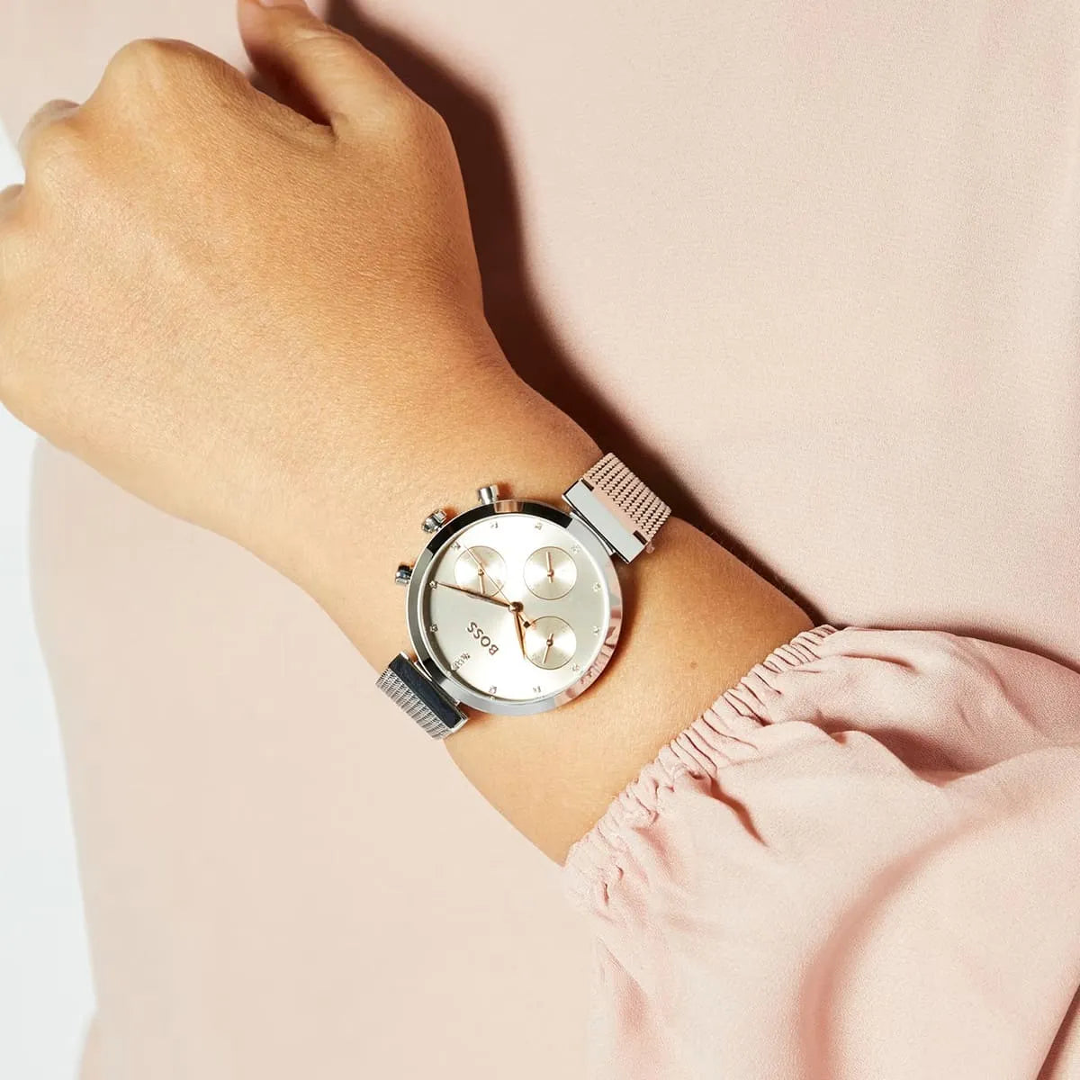 Hugo Boss Flawless women's watch worn on wrist, showing pink dial and silver mesh bracelet