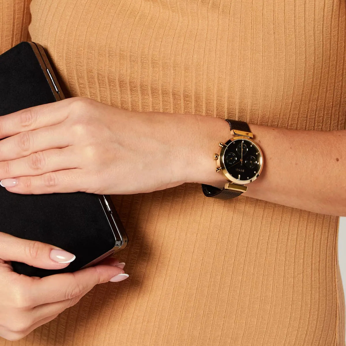 Hugo Boss Flawless chronograph watch worn on wrist with black dial and gold-tone case