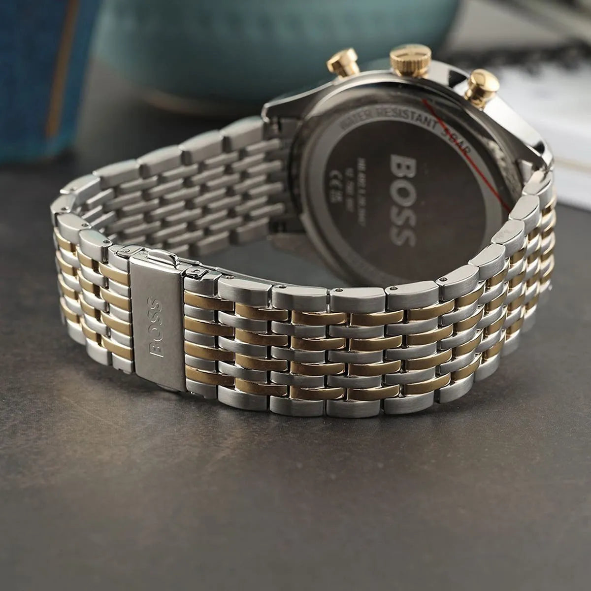 Hugo Boss Gregor watch side view displaying two-tone stainless steel and gold bracelet
