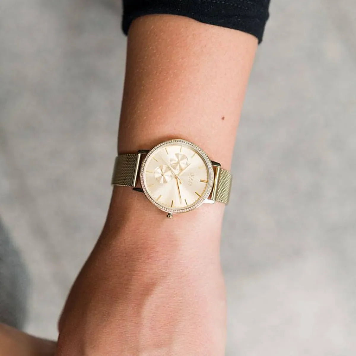 Hugo Boss Infinity gold watch worn on wrist showing dial and mesh bracelet fit