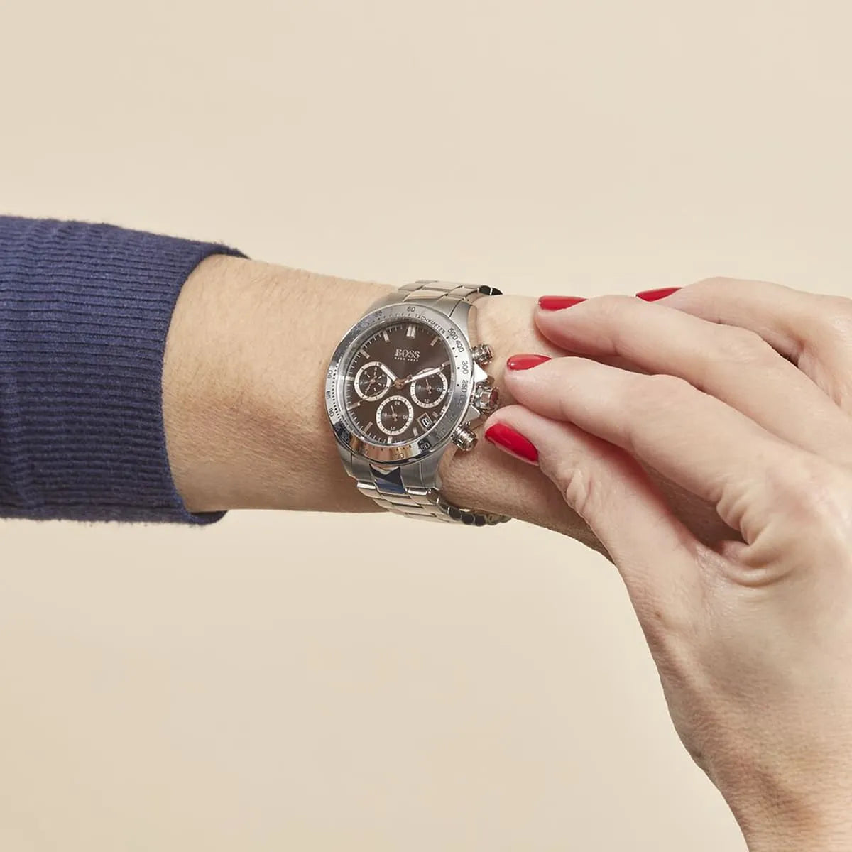Woman wearing Hugo Boss Novia watch with black dial and steel bracelet