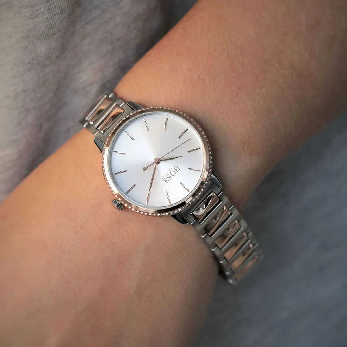 Hugo Boss Signature watch on wrist displaying silver dial with rose gold and steel strap