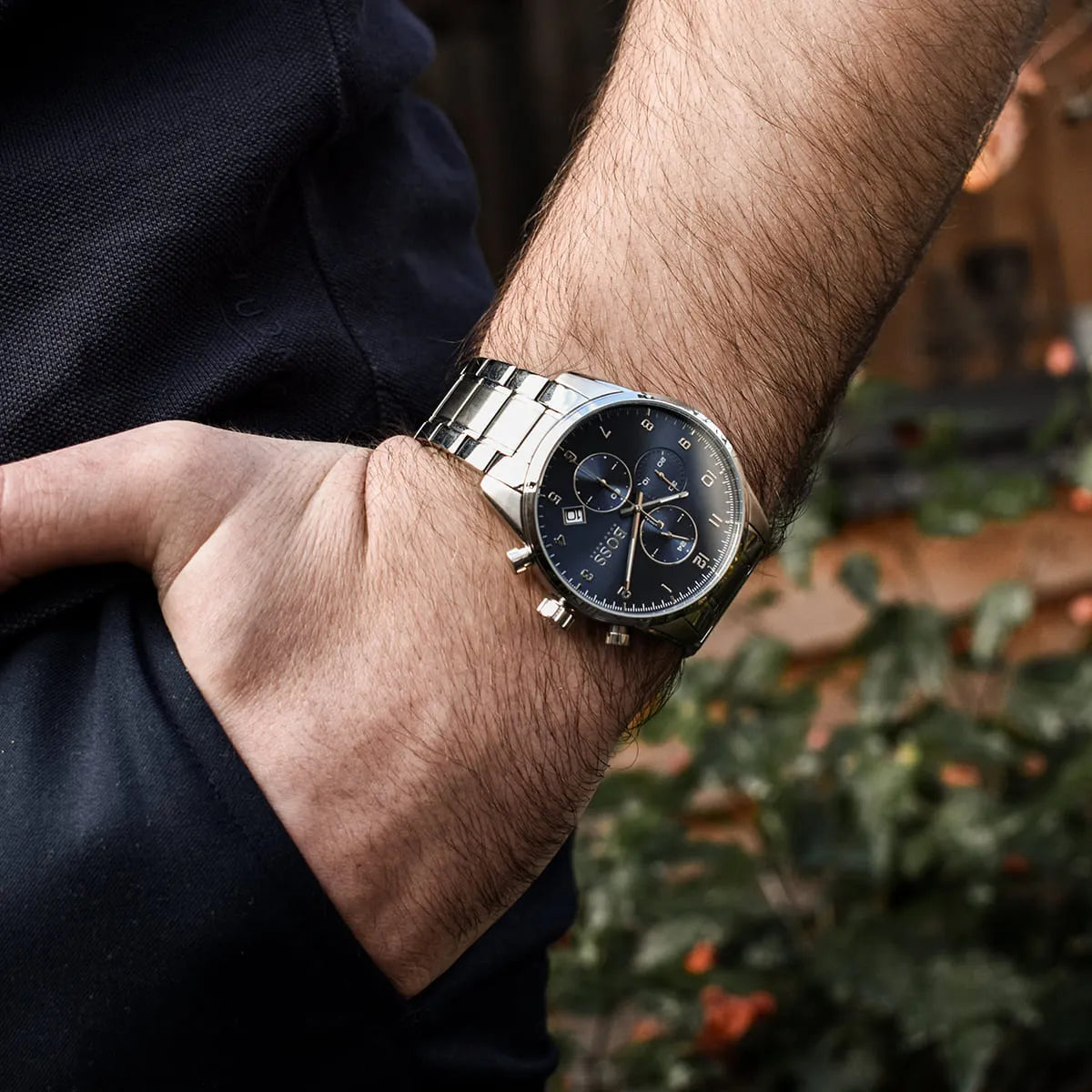 Hugo Boss Skymaster watch with blue dial and silver steel bracelet worn on wrist