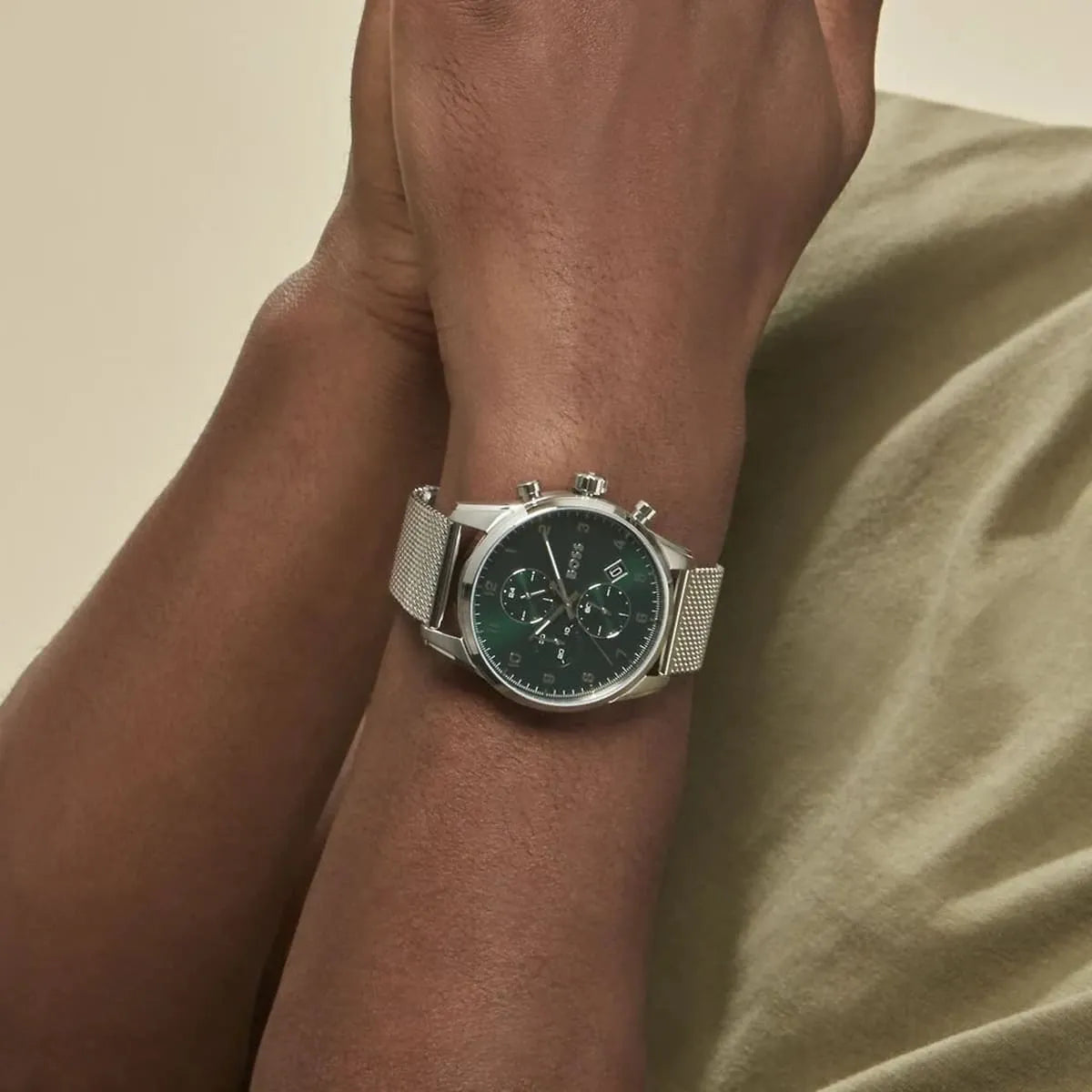 Hugo Boss Skymaster chronograph worn on wrist showing green dial and mesh bracelet