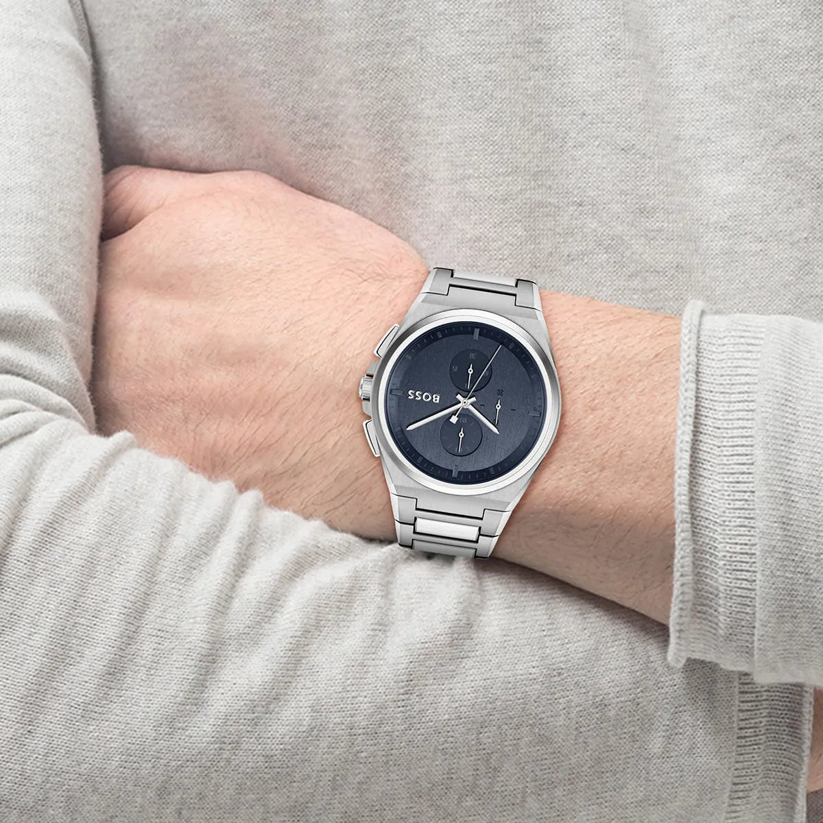 Hugo Boss Steer chronograph watch worn on wrist showing blue dial and silver bracelet