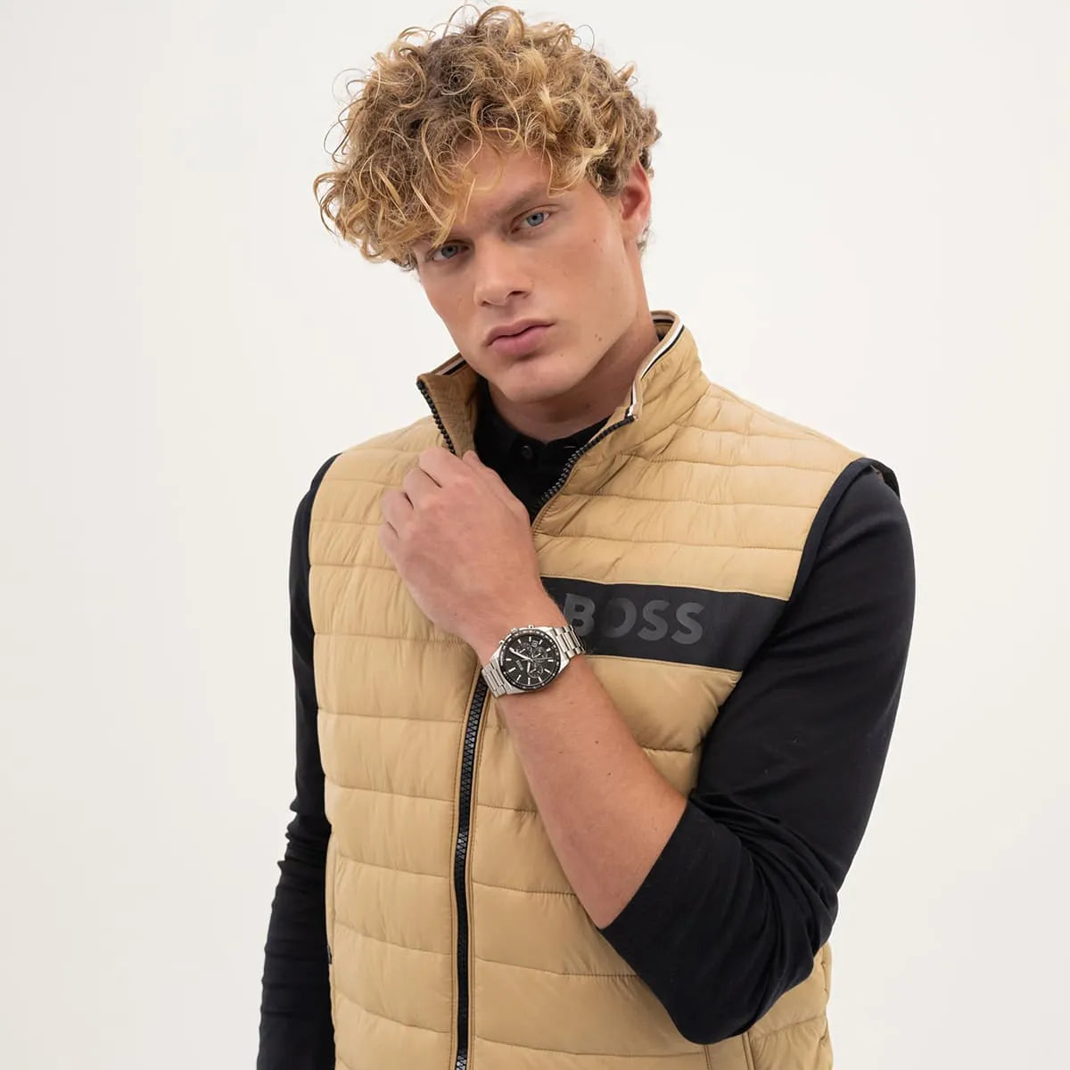 Hugo Boss Strike watch on wrist styled with beige quilted jacket