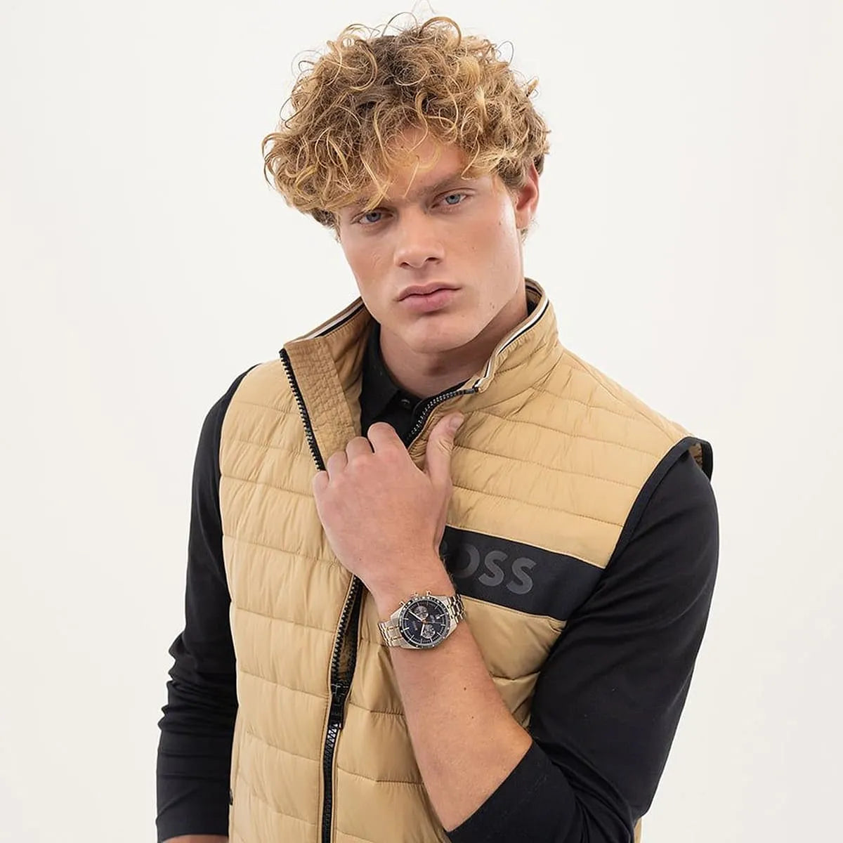 Model wearing Hugo Boss Tourmaster chronograph watch with blue dial on wrist