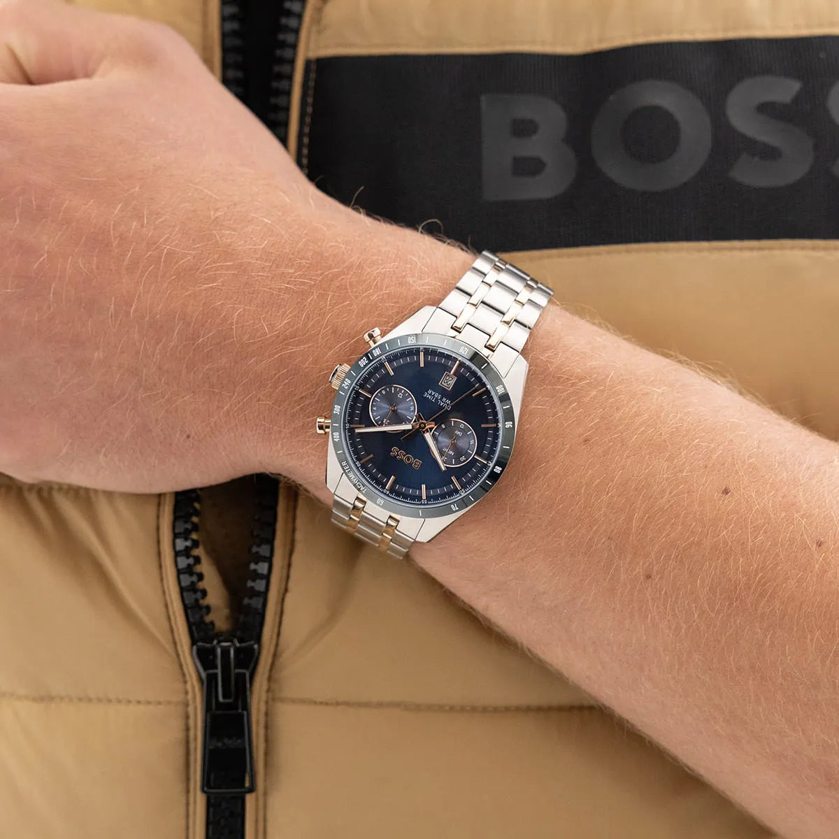 Hugo Boss Tourmaster watch worn on wrist with blue dial and stainless steel rose gold bracelet