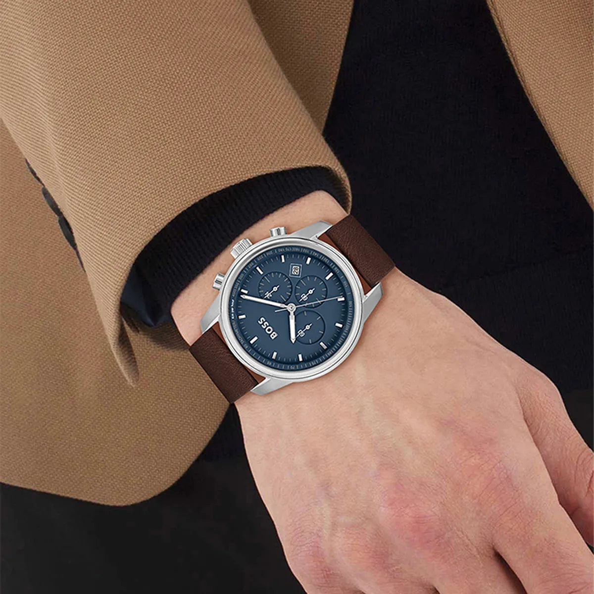 Hugo Boss Trace chronograph watch worn on wrist with blue dial and brown leather strap