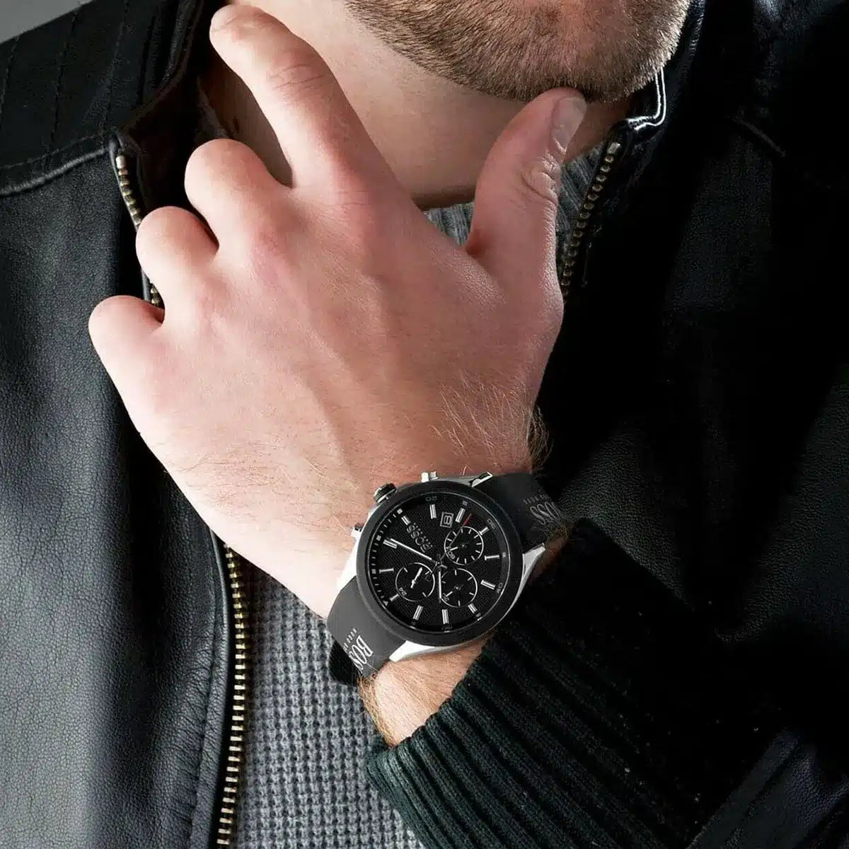 Hugo Boss Velocity black chronograph watch worn on man's wrist with leather jacket