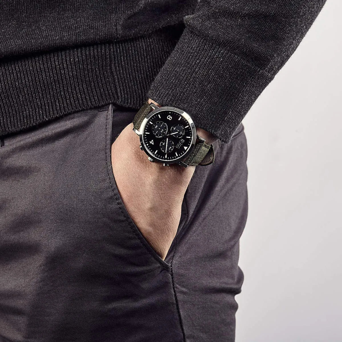 Hugo Boss Vesada chronograph watch worn on wrist against dark clothing with green fabric strap
