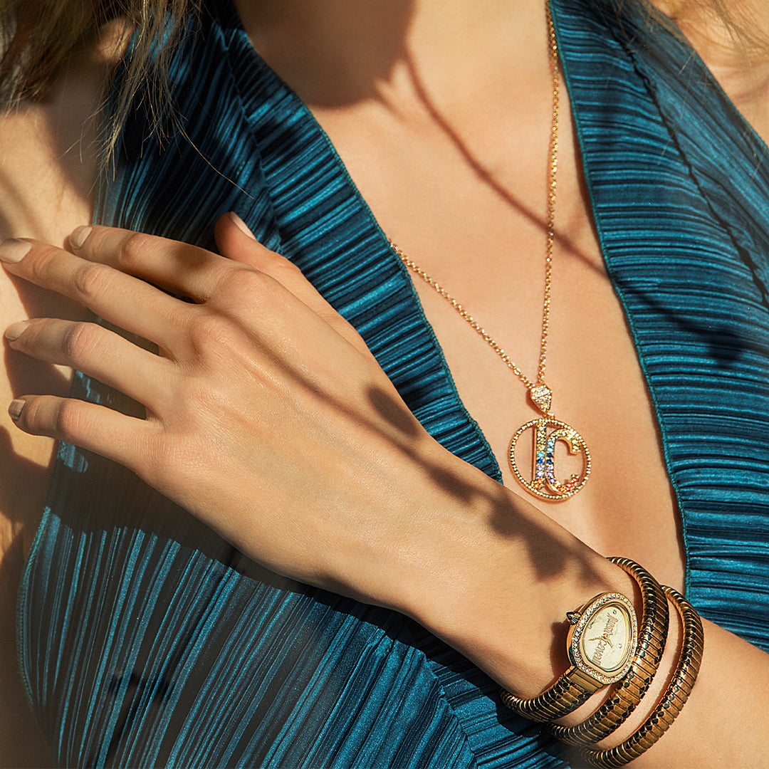 Just Cavalli Galm Chic watch worn on wrist with gold-tone snake-coil bracelet