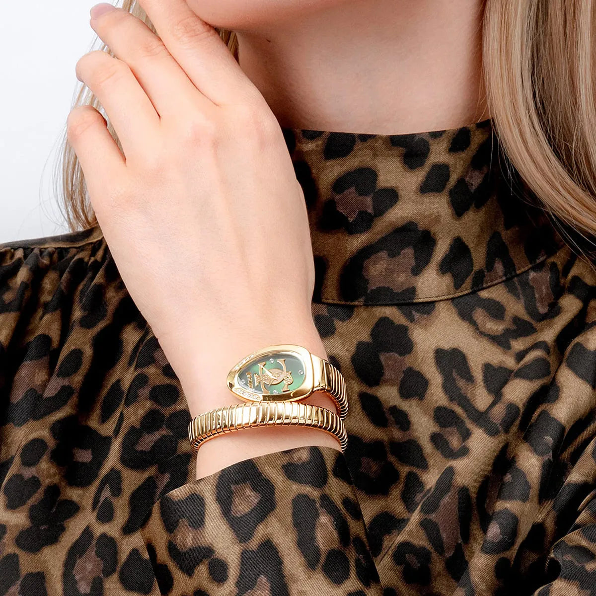 Just Cavalli Serpente women's watch worn on wrist with green dial and gold snake-shaped bracelet
