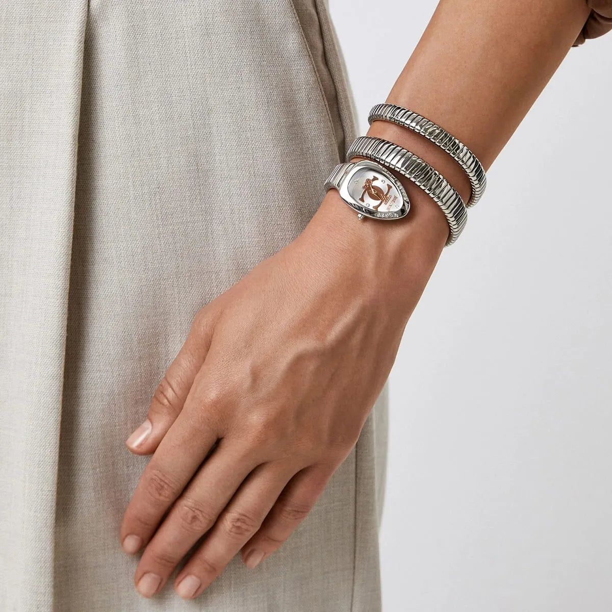 Just Cavalli Glam Chic women's watch worn on wrist with silver triple wrap snake strap