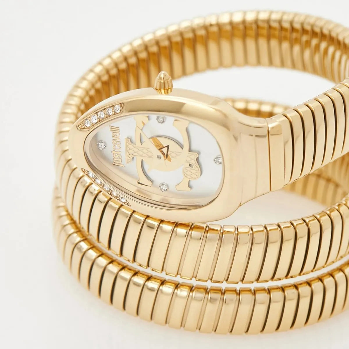 Watch dial detail showing JC logo, crystal markers and gold anchor-shaped hands