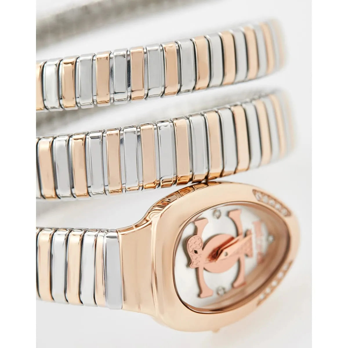 Close-up of Glam Evo 5 dial showing silver face, rose gold JC logo, crystal markers, and two-tone strap segments