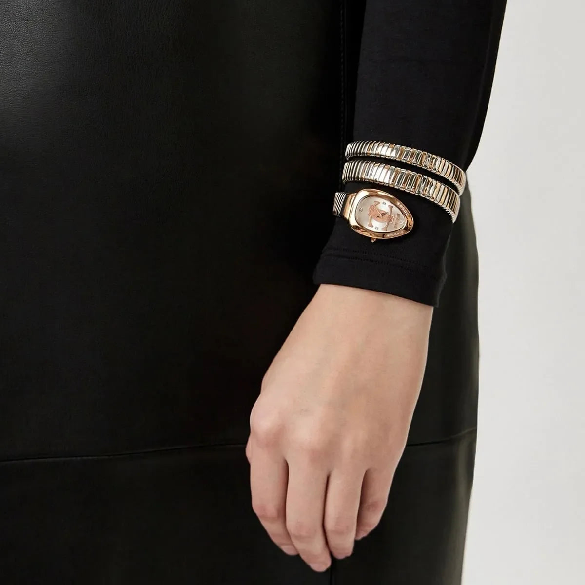 Just Cavalli Doppio watch styled on wrist with coordinating double-wrap snake strap bracelets