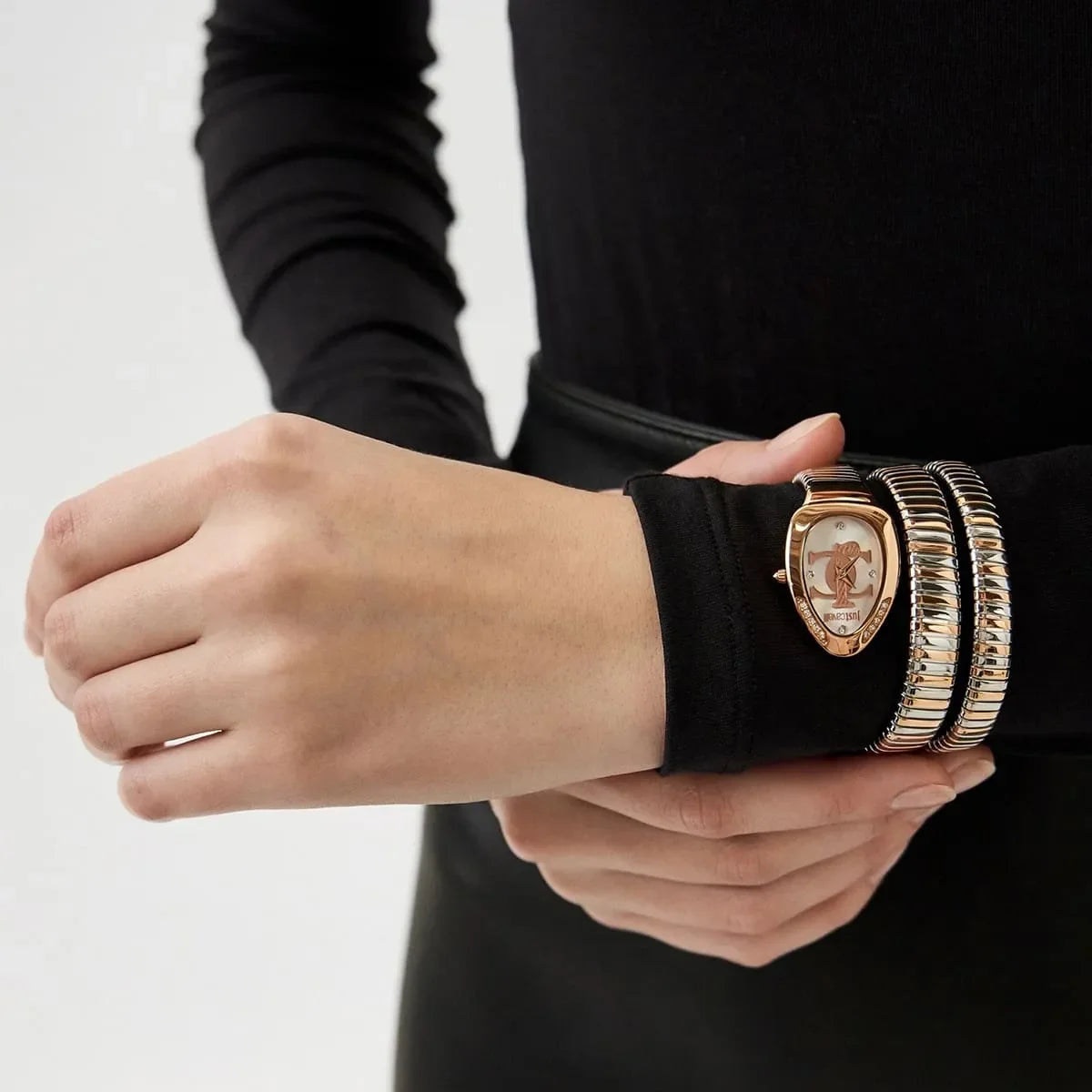 Glam Evo 5 Doppio watch worn on wrist with stacked snake bracelets in rose gold and silver tones