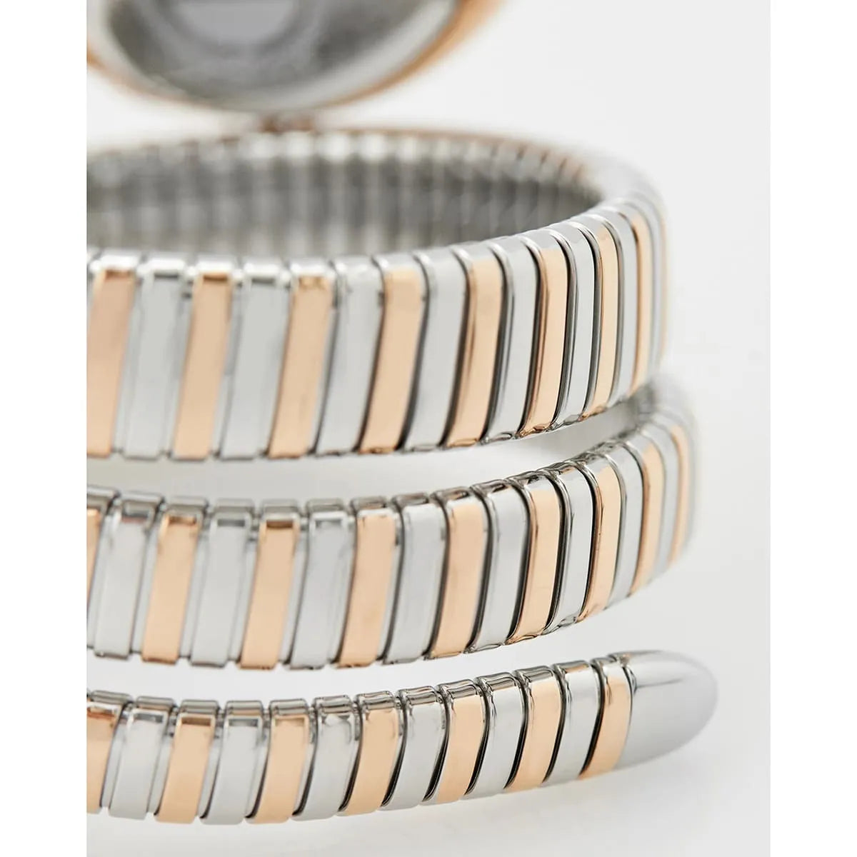 Triple-wrap snake strap detail in alternating rose gold and silver stainless steel with segmented links