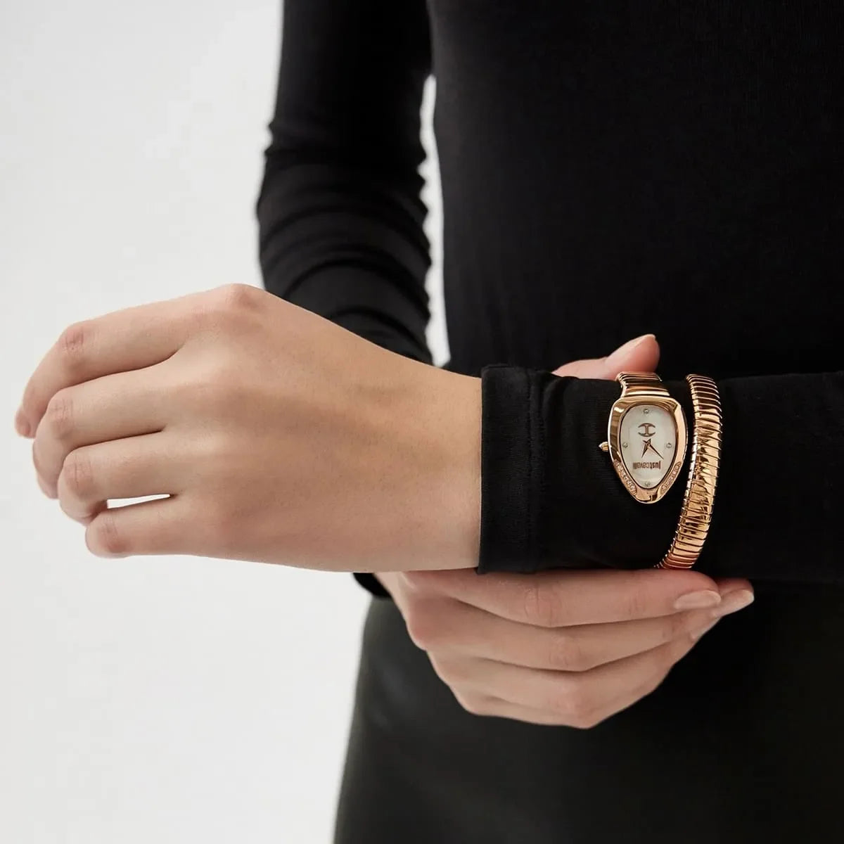 Just Cavalli Snake watch on wrist displaying rose gold case and snake-pattern stainless steel bracelet