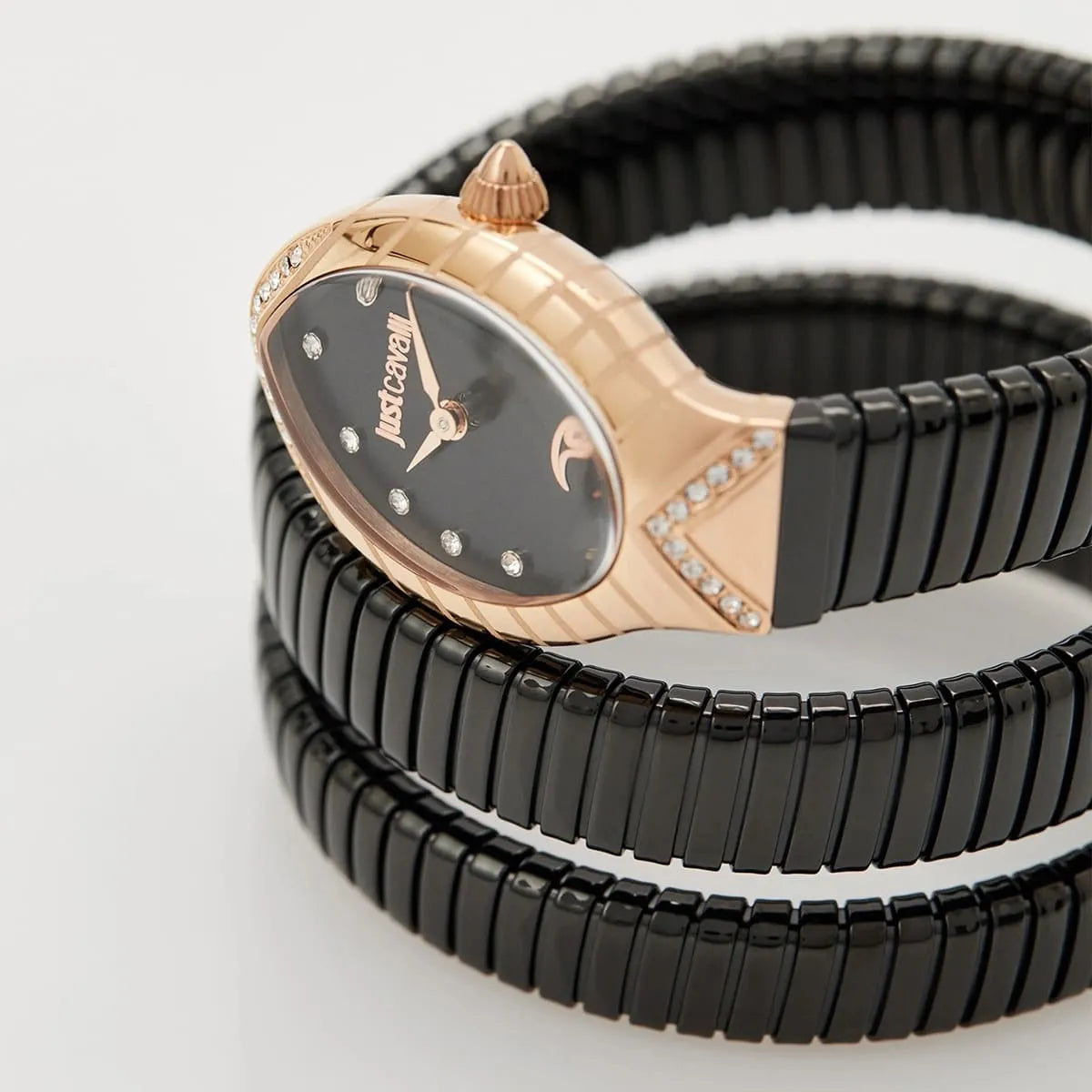 Just Cavalli Classico Lungo dial detail showing black face with crystal indices, rose gold case, and black snake strap