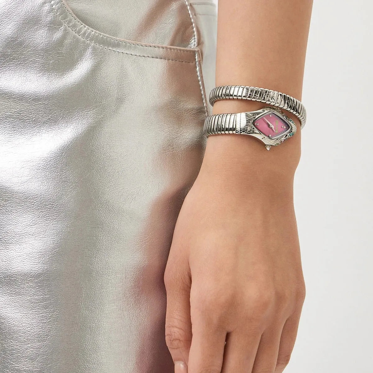 Just Cavalli Ferocious watch worn on wrist displaying pink diamond dial and silver snake-textured bracelet