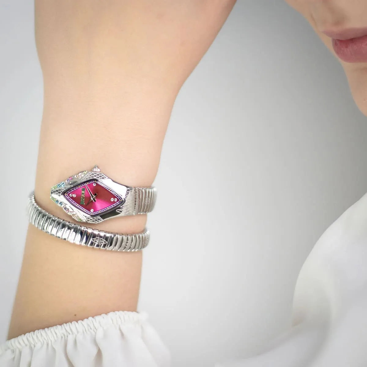 Just Cavalli Ferocious women's watch on wrist showing pink dial with colorful crystals and double-wrap bracelet