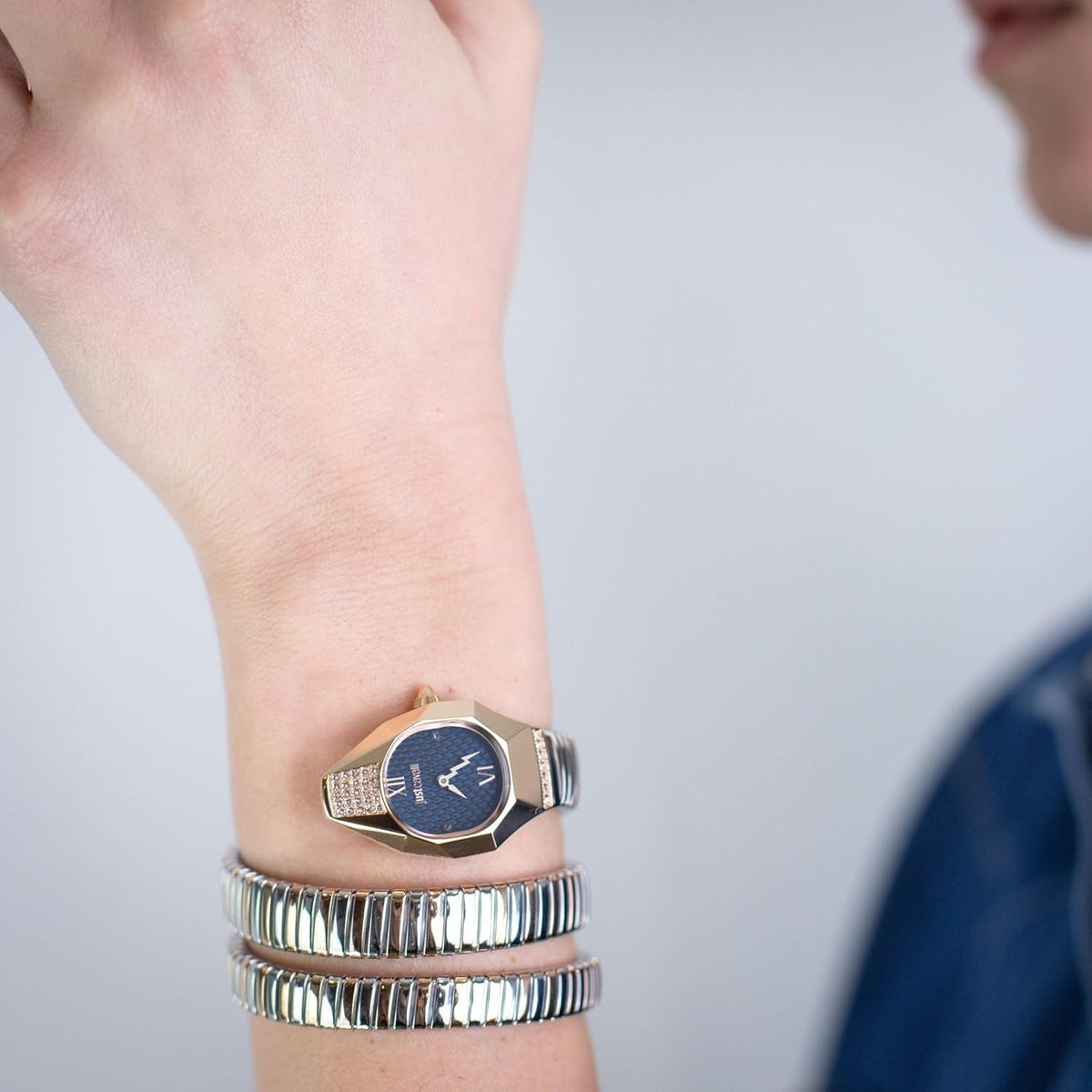Just Cavalli Lunara watch worn on wrist with blue dial and crystal-accented rose gold case
