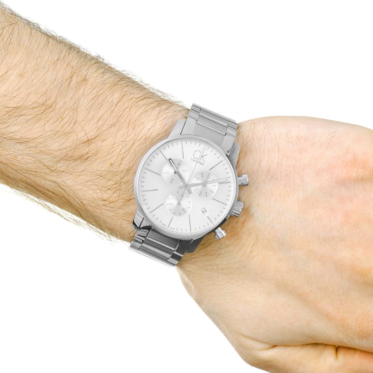 Calvin Klein City men's chronograph watch on wrist showing white dial and bracelet