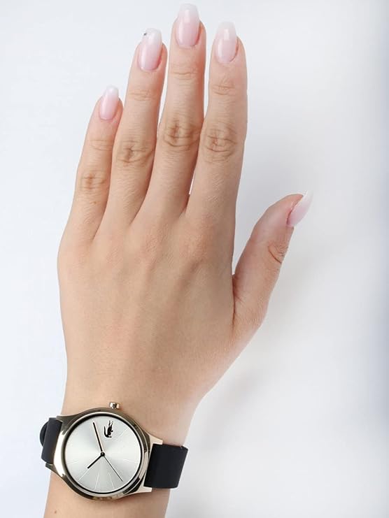 Lacoste women's watch worn on wrist, showing gold dial and black leather strap