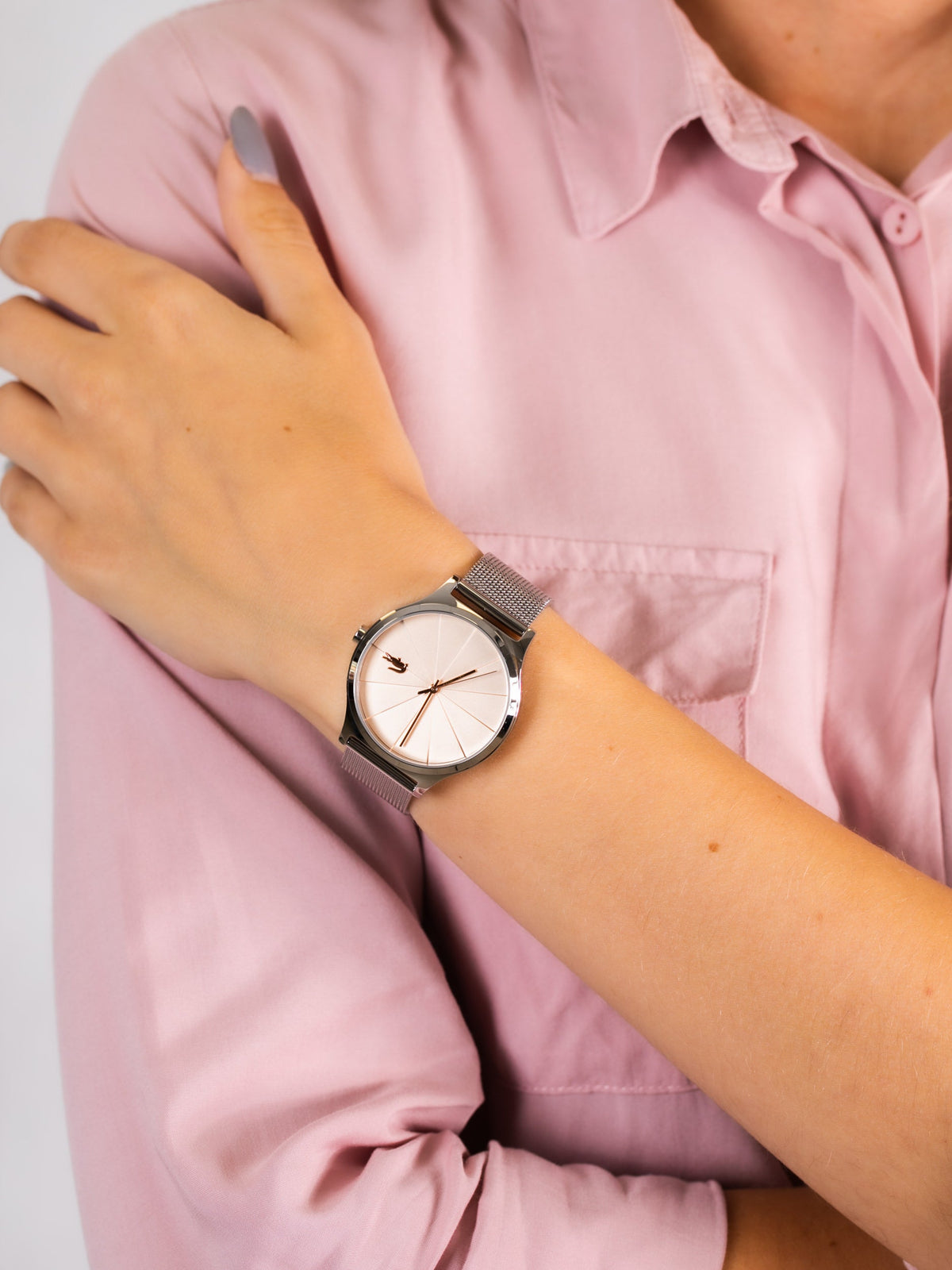 Lacoste 2001042 women's watch worn on wrist with peach dial and white face