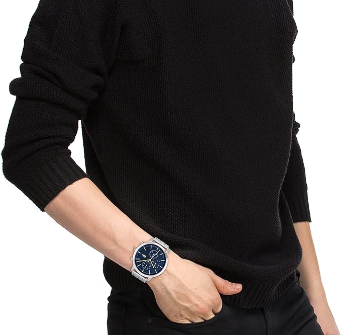 Lacoste stainless steel mesh watch with blue dial worn on wrist
