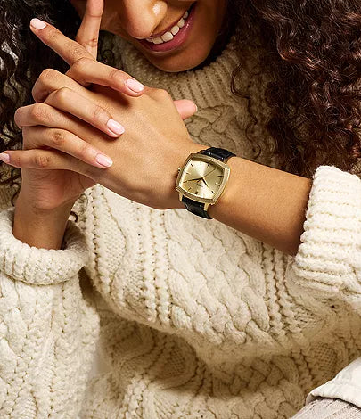 Fossil Machine Luxe limited edition watch on model wrist with gold-tone case and black leather strap