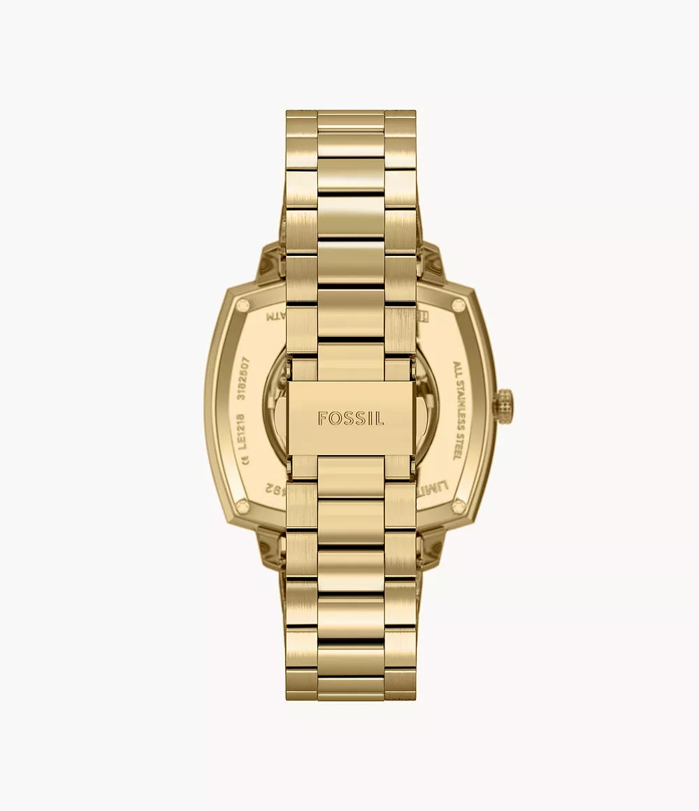 Top-down angled view of gold-tone automatic watch with skeleton dial and bracelet