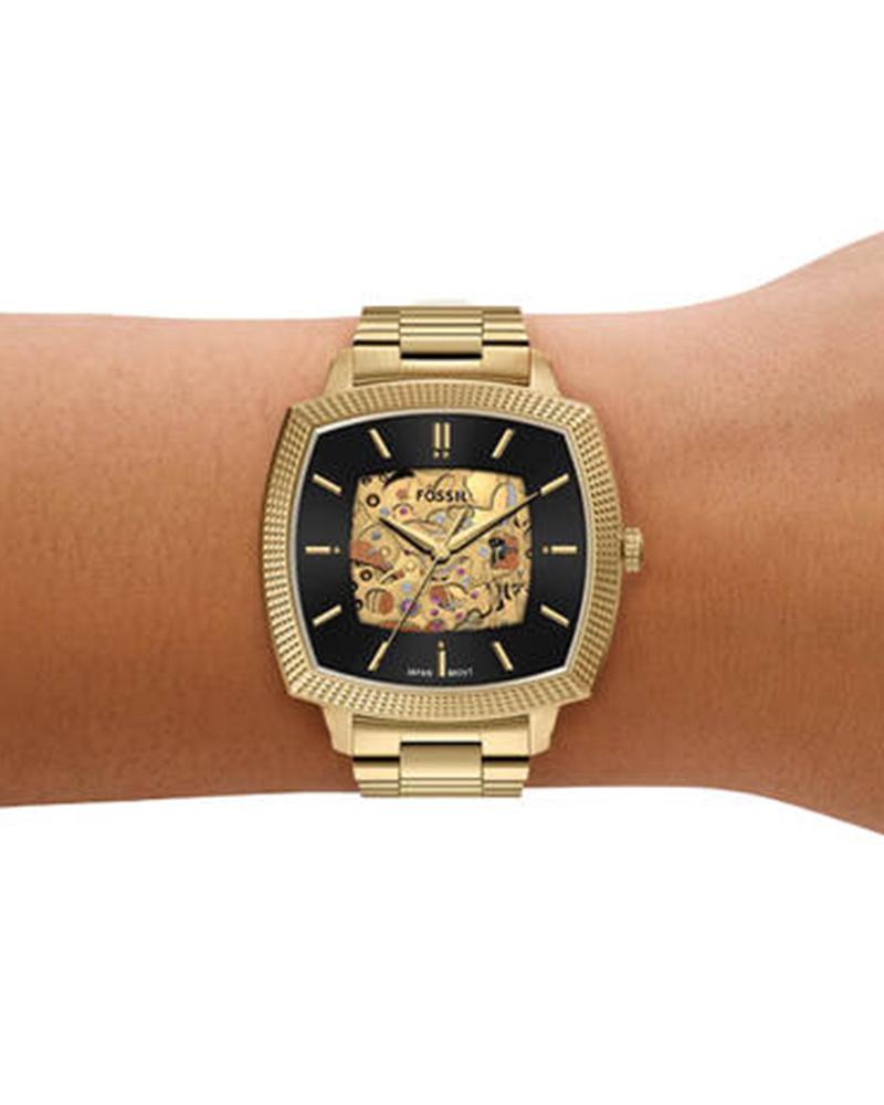 Fossil Machine Luxe automatic gold watch worn on wrist showing dial and bracelet
