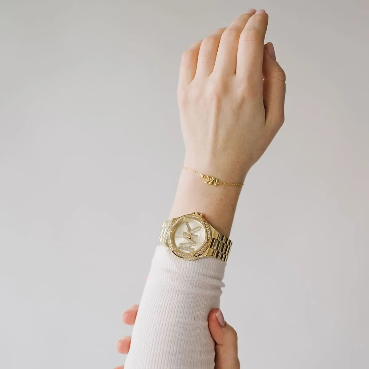 Gold-tone Lennox watch and bracelet set worn on wrist