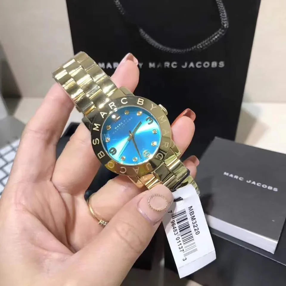 Marc by Marc Jacobs Amy blue watch worn on wrist with Marc Jacobs shopping bag and box