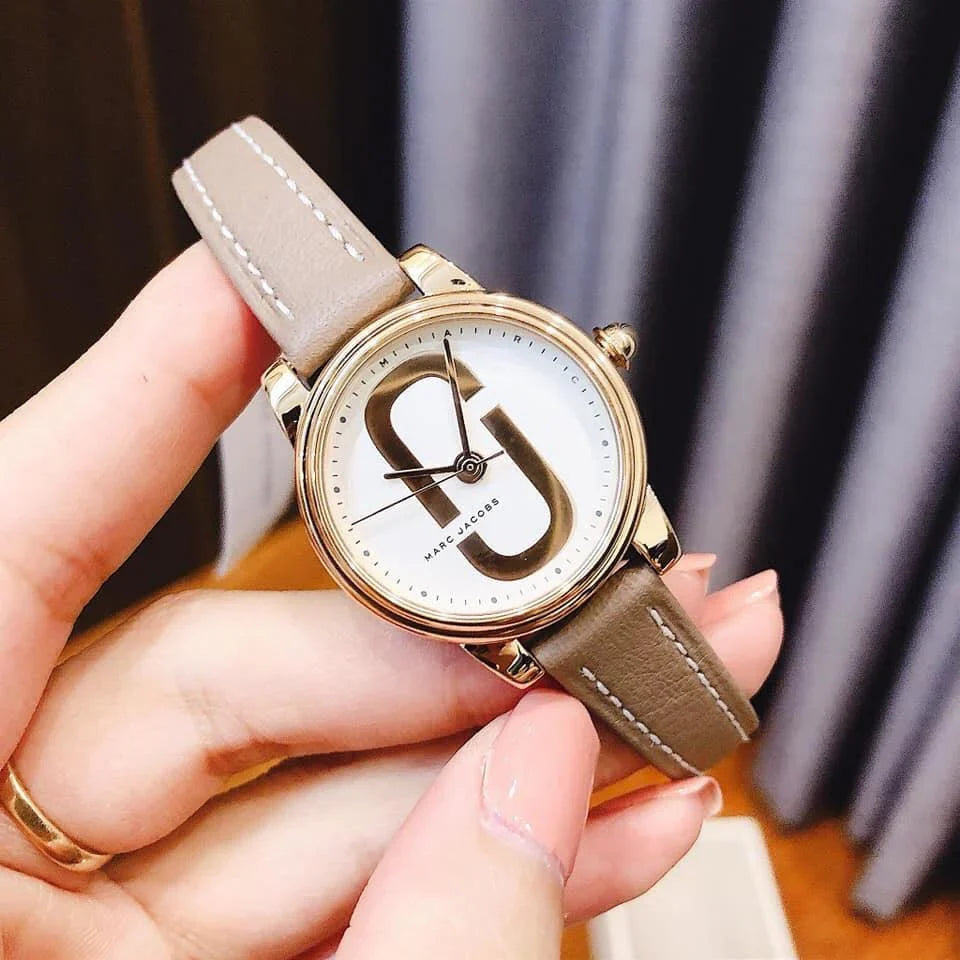 Marc Jacobs Corie watch worn on wrist displaying white dial with rose gold MJ logo