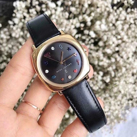 Marc Jacobs Mandy watch worn on wrist showing gold case and black leather strap