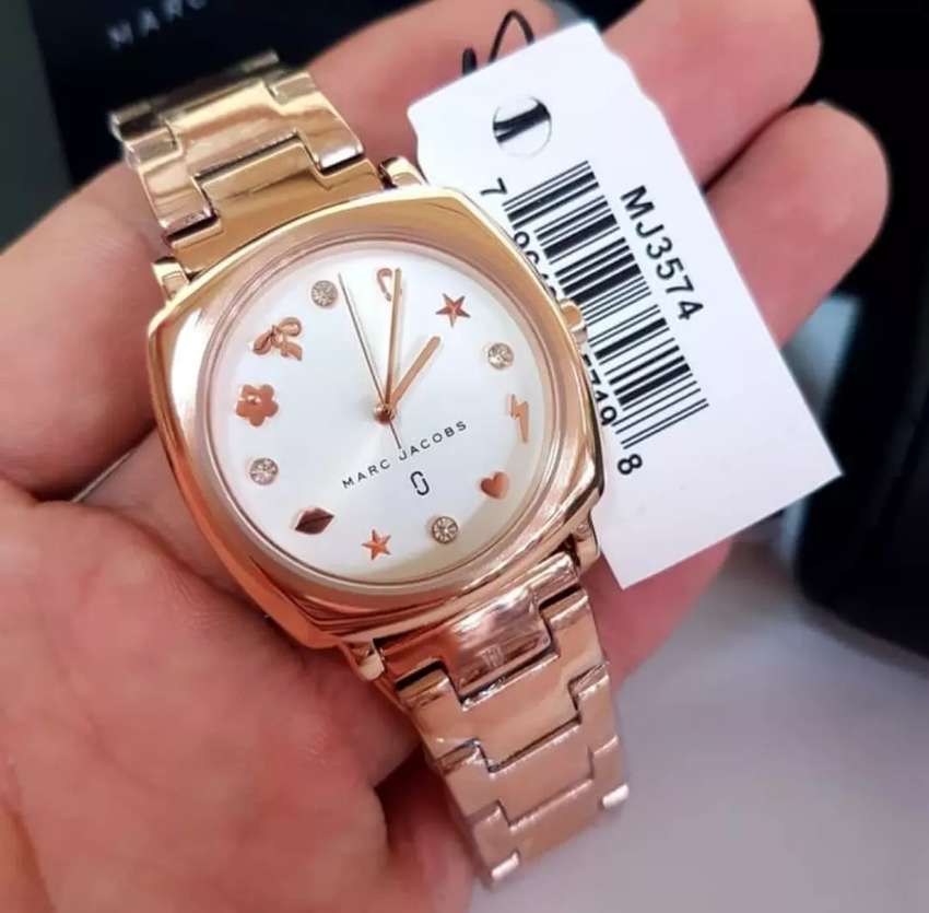 Marc Jacobs Mandy MJ3574 watch held in hand with product tag visible showing white dial and decorative elements