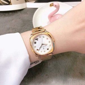 Marc Jacobs Mandy white dial rose gold watch on wrist showing square case and link bracelet