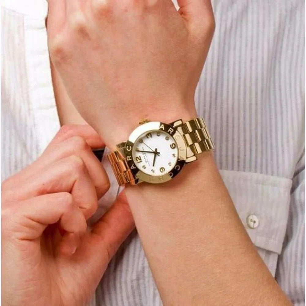 Marc By Marc Jacobs Amy watch worn on wrist, showing gold-tone bracelet and white dial
