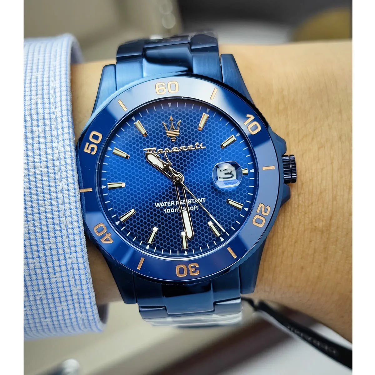 Maserati Competizione blue dial watch worn on wrist with blue steel bracelet