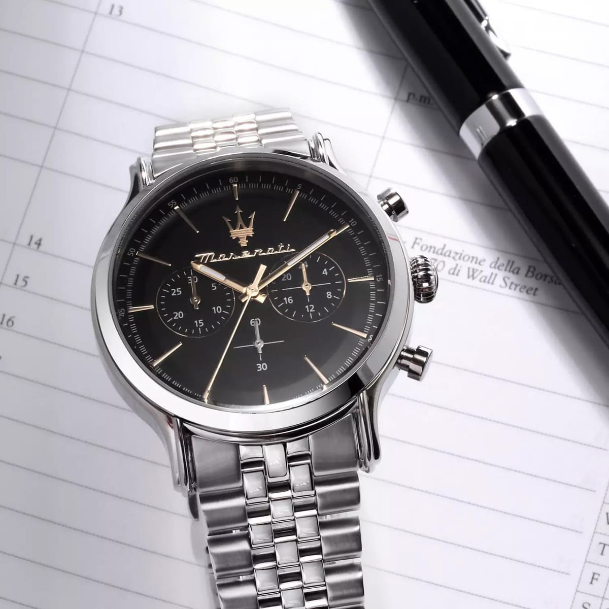 Maserati Epoca chronograph watch on wrist and notebook, lifestyle product shot